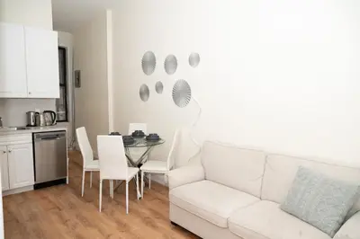 a living room with a white couch and a table at East Village Center Apartment7 w Full Amenities Great New York Location in New York