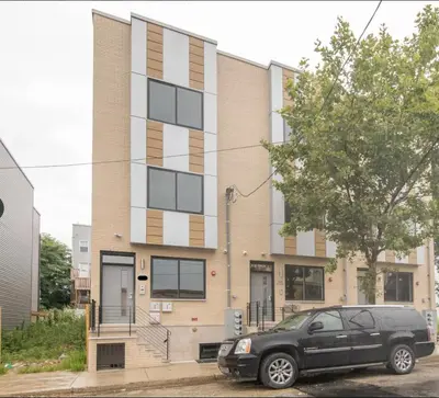 a black car parked in front of a building at 3BR3Bath Home with King Beds Sleeps 8 in Philadelphia