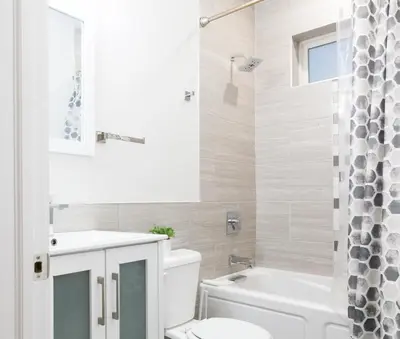 a bathroom with a toilet and a sink and a tub at Spacious 3-Bed3BathKing BedsTVWasherDryer in Philadelphia