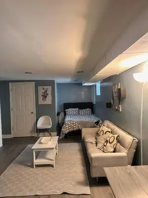 a living room with a couch and a bed at Suhira Hospitality Group in Lansdowne