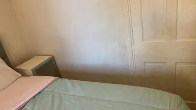 a small room with a bed and a door at 2218NColoradoC in Philadelphia