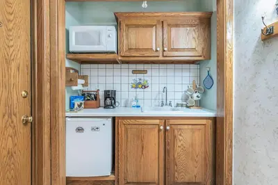 a small kitchen with a sink and a microwave at Quiet Getaway with Queen Bed & Wi-Fi in Clarks Summit