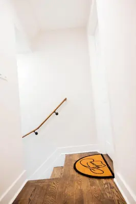 a rug on the floor in a room with a white wall at Joynest Loft - Private Entry & Bath in Newark