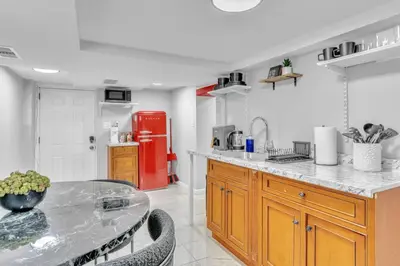 a kitchen with a table and a red refrigerator at Cozy Private Apartment Near NYC Light Rail in Bayonne