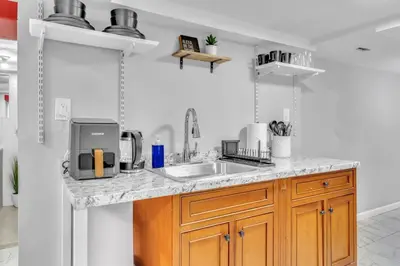 a kitchen with a sink and a counter top at Cozy Private Room in Shared Space NYC Light Rail BSMT A in Bayonne