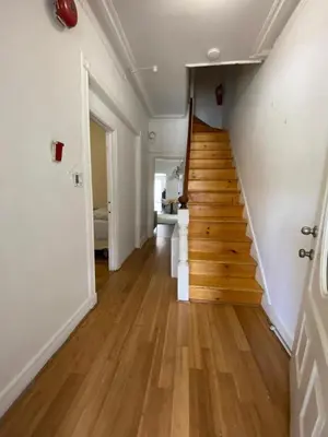 a hallway with a wooden staircase in a house at Cjay home 3 in Jersey City