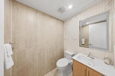a bathroom with a toilet and a sink and a mirror at Double Room at a shared Apartment near Times Square in New York