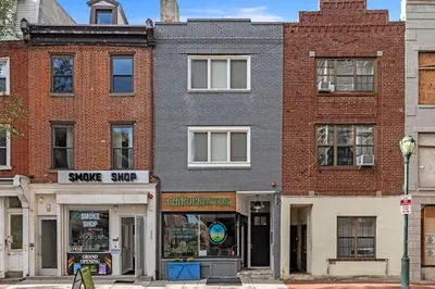 a brick building with a store on a street at Washington Square West Unit B in Philadelphia