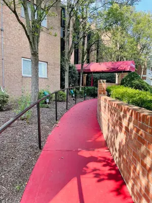 a red path in front of a brick building at Modern 2BR2BA Extended Stay Discounts in Elkins Park