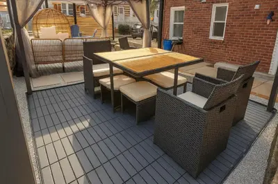 a wooden table and chairs on a patio at Nice 3BR Apt | 3 Beds |15 Min to NYC/Manhattan! in North Bergen