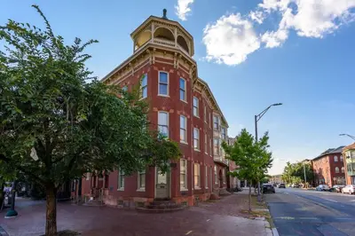 a red brick building with a clock tower on a street at Capitol View Retreat - 3F Fast Wi-Fi Cozy in Harrisburg