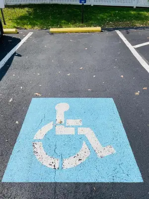 a blue handicapped sign in a parking lot at Updated 1BR Apartment Moss Rehab Save Monthly in Jenkintown