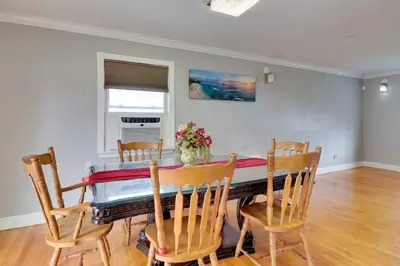 a dining room with a table and chairs at The Vault Your Fun Secured in Hillside