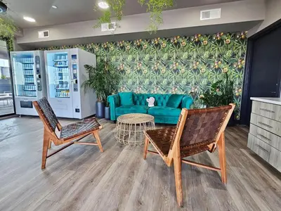 a living room with a green couch and two chairs at Chic 1BR Old City Apt with King Bed, City View, and Gym in Philadelphia