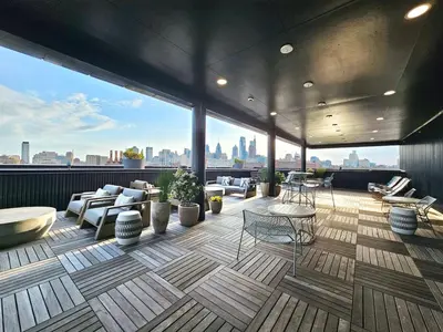 a rooftop patio with furniture and a view of the city at 2 BR in the heart of an old city in Philadelphia