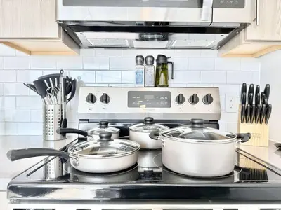 a kitchen stove with three pots and pans on it at 1BR Apt King Bed FREE Parking Gym - RoofTop 609 in Philadelphia