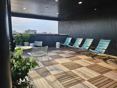 a group of chairs and tables on a patio at 1BR Apt King Bed FREE Parking Gym - RoofTop 609 in Philadelphia