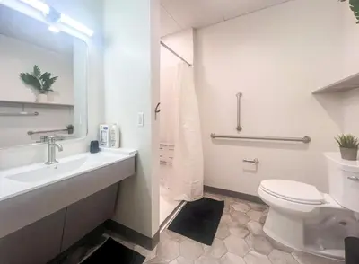 a white bathroom with a toilet and a sink at 401 Modern Brand New Studio Apartment in Old Bridge