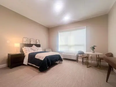 a bedroom with a bed and a large window at 415 Modern Brand New Studio Apartment in Old Bridge