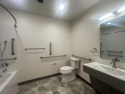 a bathroom with a toilet and a sink and a mirror at 409 Modern Brand New Studio Apartment in Old Bridge