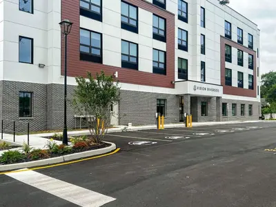 an empty street in front of a large building at 409 Modern Brand New Studio Apartment in Old Bridge