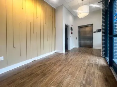 an empty room with wood floors and a hallway at 403 Modern Brand New Studio Apartment in Old Bridge