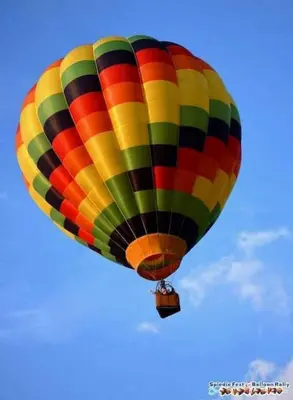 a colorful hot air balloon flying in the sky at Intimate PR near Binghamton University. Free Park in Johnson City