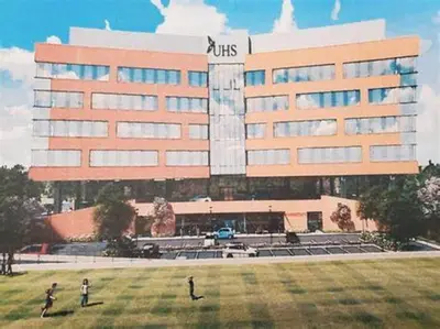 two people standing in front of a large building at Lovely PR near Lourdes Hospital by Binghamton in Johnson City