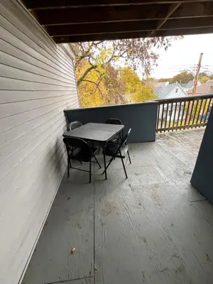 a patio with a table and chairs on a balcony at Lovely PR near Lourdes Hospital by Binghamton in Johnson City