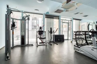 a gym with treadmills and elliptical machines at Blueground Midtown South rooftop nr Bryant Park NYC-2028 in New York