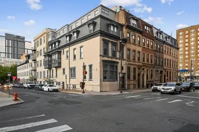 a city street with cars parked on the side of a building at Sunny 1BR in Center City with King Sized Memory Foam Sofa Bed in Philadelphia