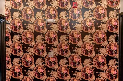a wall with a bunch of pictures on it at Large Studio w 2 Beds and Balcony (C) in Philadelphia