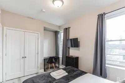 a bedroom with a bed and a window at Large Bi-Level 2BR Loft in Old City that Sleeps 8 in Philadelphia
