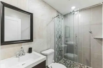 a bathroom with a shower and a sink and a toilet at Large Bi-Level 2BR Loft in Old City that Sleeps 8 in Philadelphia