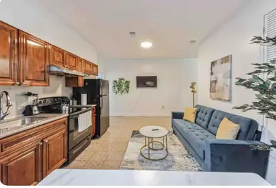 a kitchen and living room with a blue couch at Across from Convention Center 4F - Sleeps 6 - 4F in Philadelphia