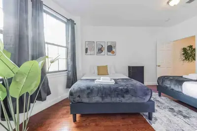 a bedroom with a bed and a large window at Across from Convention Center - Sleeps 6 - 3F in Philadelphia