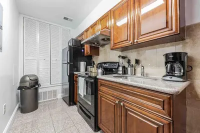 a kitchen with a sink and a stove and refrigerator at Cozy Studio Across from Convention Center - 3R in Philadelphia