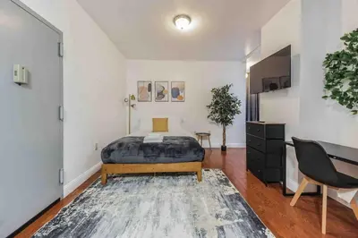 a bedroom with a bed and a desk in it at Studio Across the Street from Convention Center 2R in Philadelphia