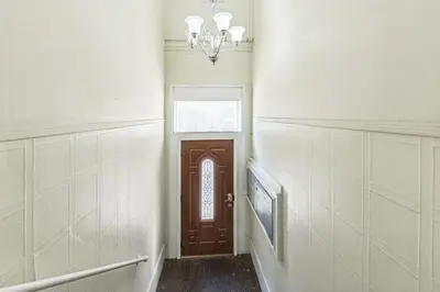 a hallway with a door and a chandelier at Large Historical Center City 1BR that Sleeps 4 in Philadelphia