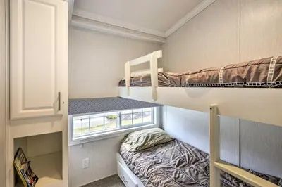 a small room with two bunk beds and a window at Romantic Cottage and Suite Close to Ski Trails in Pleasant Mount