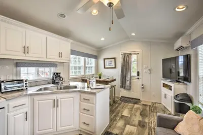 a kitchen with white cabinets and a sink at Romantic Cottage and Suite Close to Ski Trails in Pleasant Mount