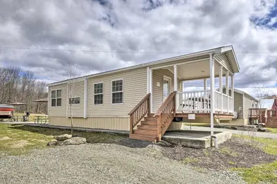 a small house with a porch and stairs on it at Hidden Gem Cottages and Suites near Ski Resorts in Pleasant Mount