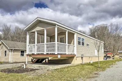 a house with a large porch on the side of it at Hidden Gem Cottages and Suites near Ski Resorts in Pleasant Mount