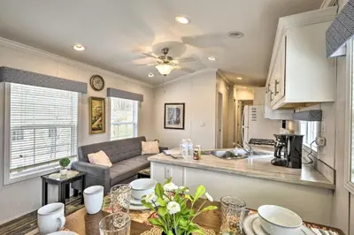 a kitchen and living room with a couch and a table at Forest Hideout Cottage Close to Camps and Ski Resorts in Pleasant Mount