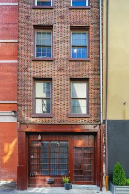 a brick building with two garage doors on it at Spacious Family Home in Philadelphia in Philadelphia