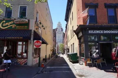 a city street with shops and buildings on a city at Spacious Family Home in Philadelphia in Philadelphia