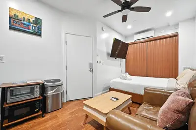 a living room with a couch and a bed at Spacious Family Home in Philadelphia in Philadelphia