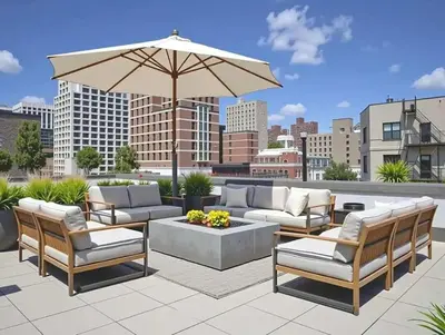 a patio with couches and a table and an umbrella at 19-4G 2BR 2Baths Luxury Apt East Village in New York
