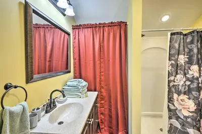 a bathroom with a sink and a red shower curtain at Quadruple Suites At Equestrian House in Pleasant Mount