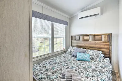 a bedroom with a bed and a window at Premium Cottages And Suites At Equestrian House in Pleasant Mount